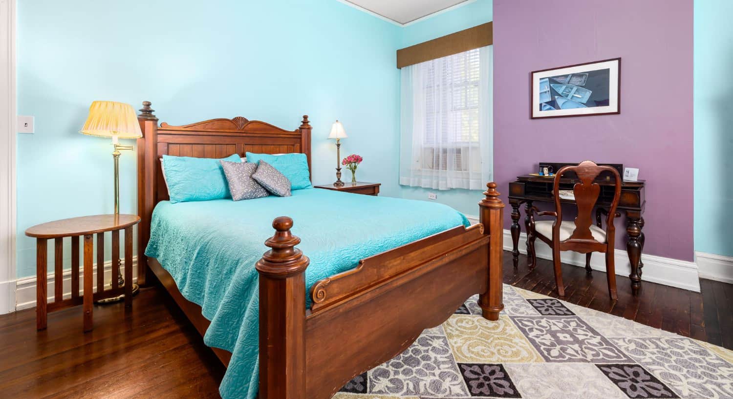 The Jasmine Room bedroom with light blue and purple walls and antique wooden furniture