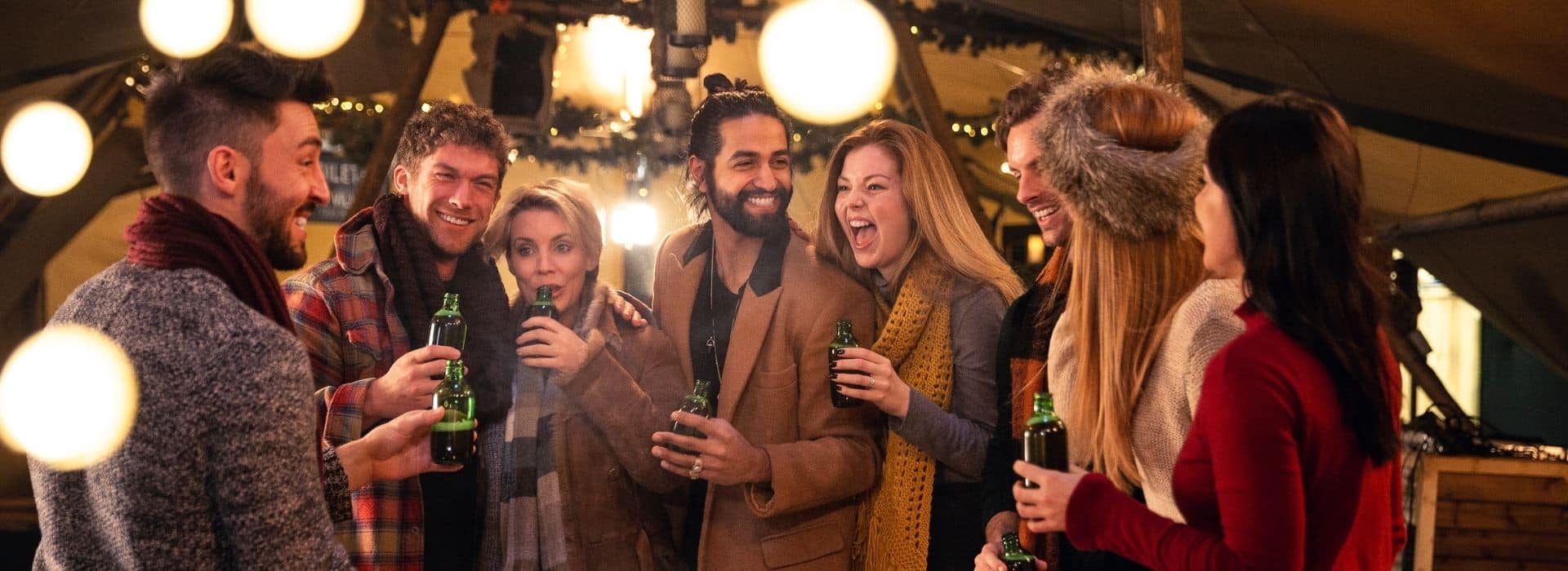 A group of friends gathered at a holiday event wearing scarves.