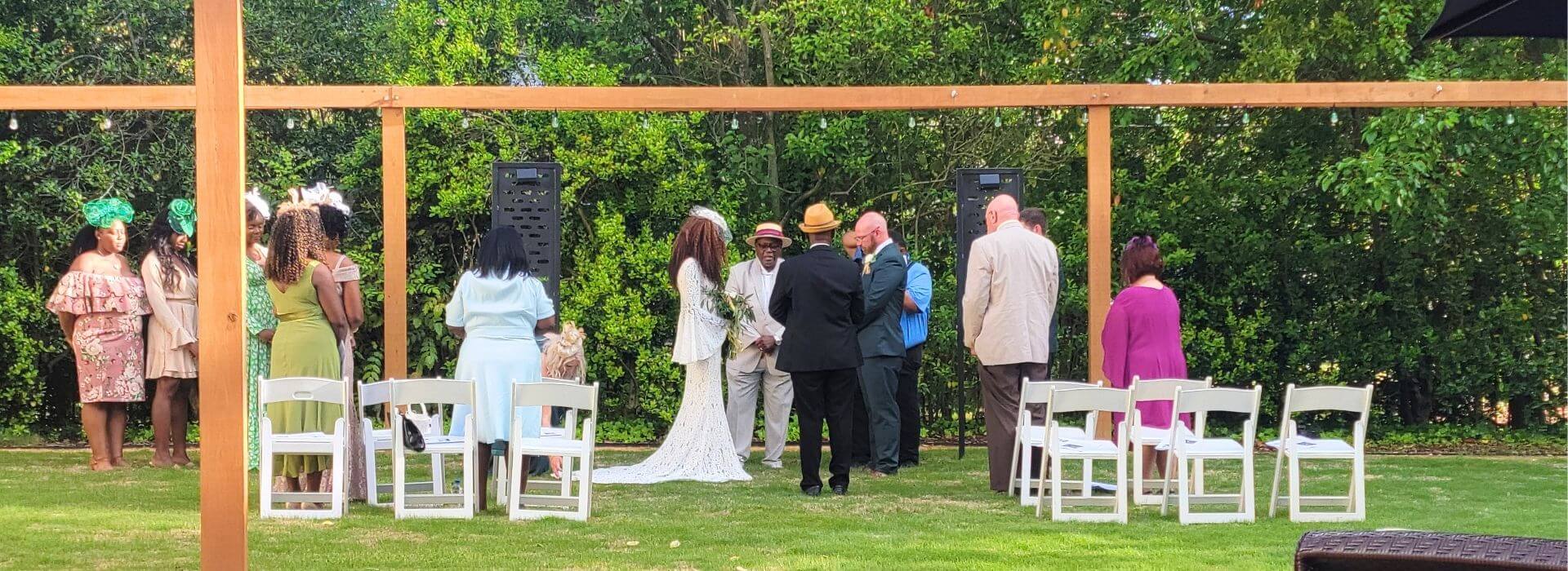 A bride and groom exchanging vows in the garden at Morehead Manor.